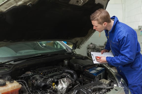 image of man inspecting car